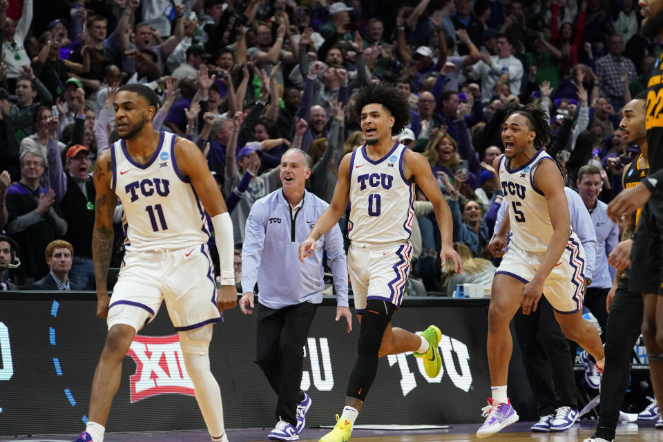 TCU guard Rondel Walker, guard Micah Peavy and forward Chuck O'Bannon Jr., from left, celebrate as time runs out in the team's first-round college basketball game against Arizona State in the men's NCAA Tournament on Friday, March 17, 2023, in Denver. (AP Photo/John Leyba)