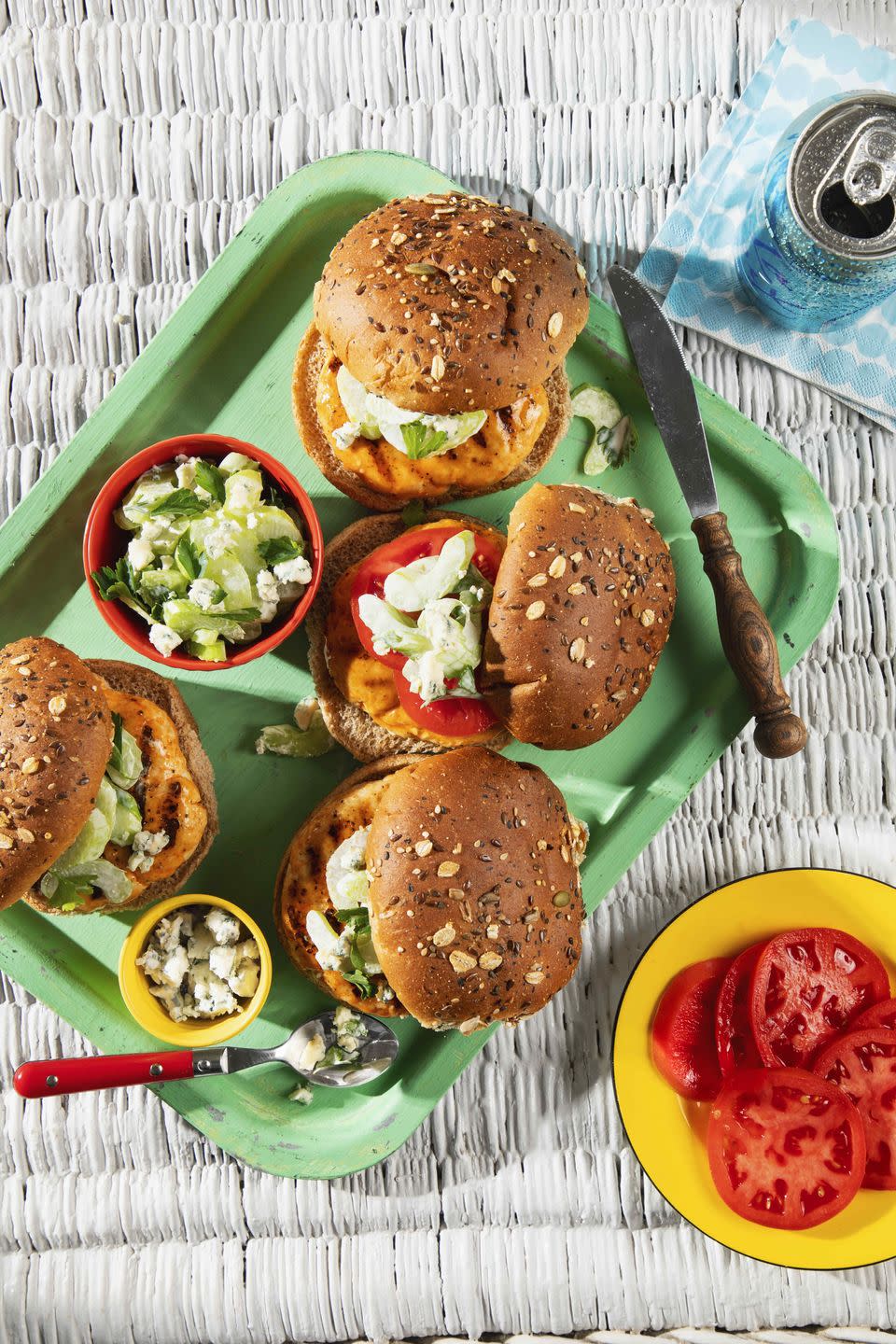 turkey burgers with blue cheese–celery slaw arranged on a greet serving tray