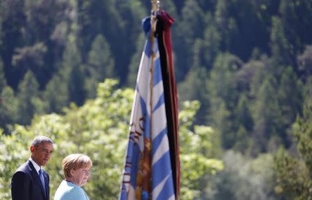 U.S. President Barack Obama and German Chancellor Angela Merkel make speeches after signing the guest book in Kruen, Germany June 7, 2015. REUTERS/Matthias Schrader/Pool