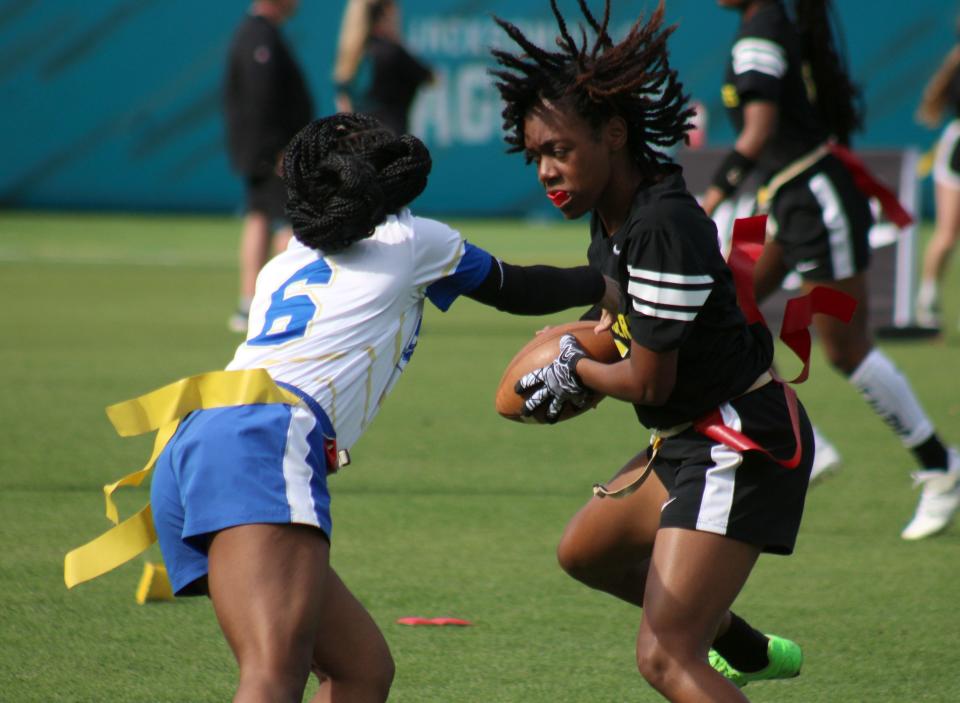 Ed White receiver Tamiya Jackson (5) dodges a flag pull from a Mainland defender during the Jaguars Prep Girls Flag Football Preseason Classic in 2023.