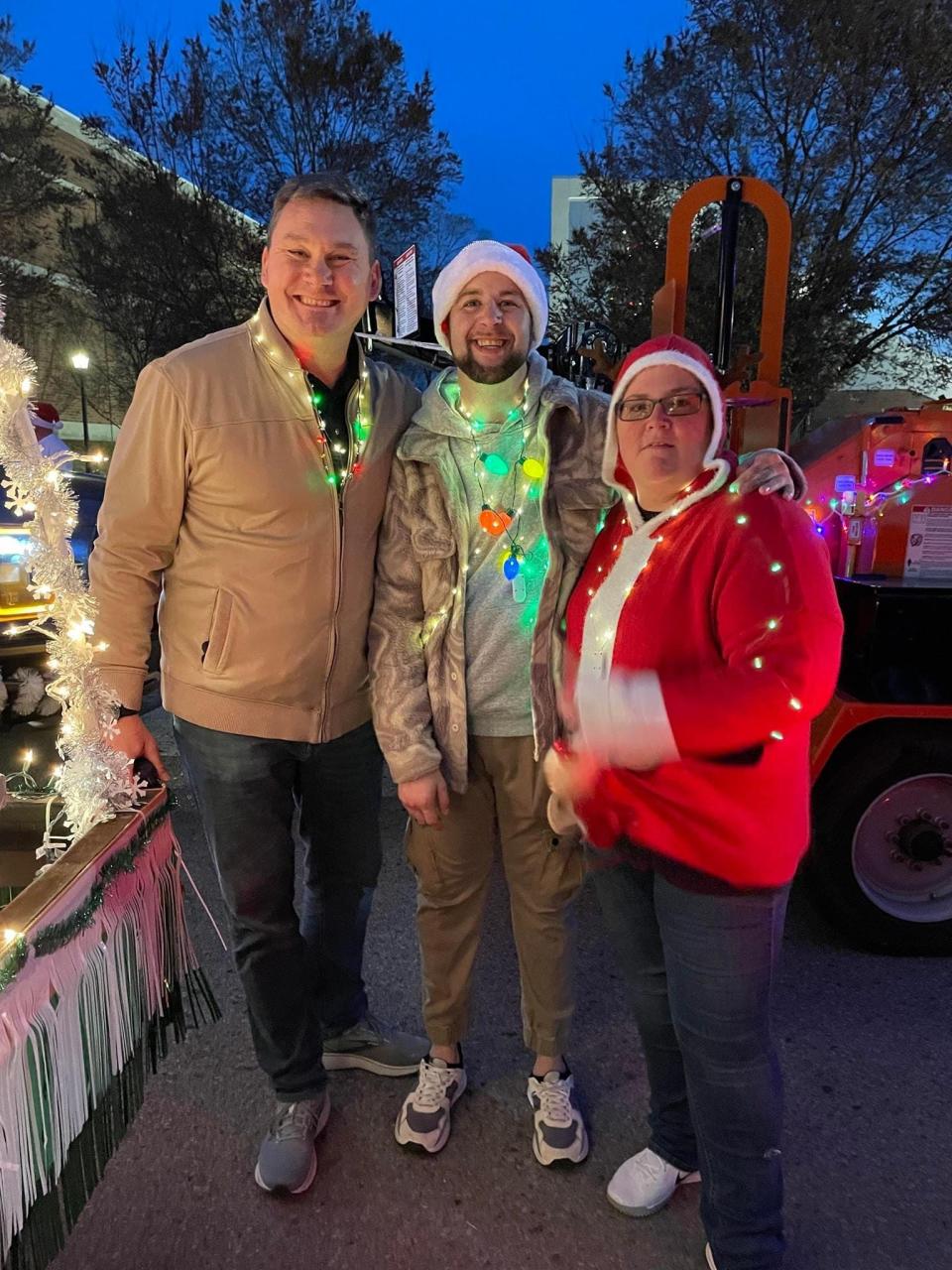 Big Brothers Big Sisters of Clarksville's marketing and communications director ​Joshua Peltz, community based program specialist Kyle Pearce and program manager Thomasa Munroe at the 2023 Clarksville Christmas Parade.
