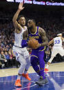 Los Angeles Lakers' LeBron James, right, makes his move against Philadelphia 76ers' Ben Simmons, left, of Australia, during the first half of an NBA basketball game, Sunday, Feb. 10, 2019, in Philadelphia. (AP Photo/Chris Szagola)