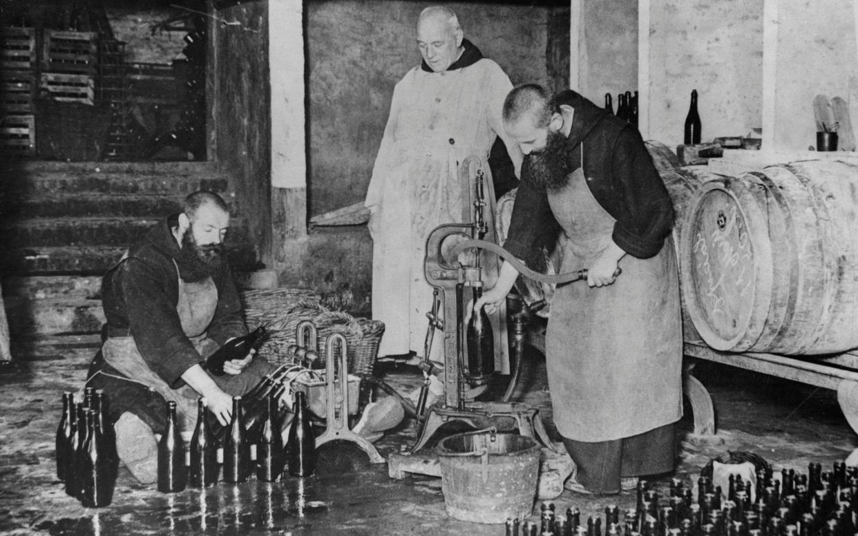 Monks work in the bottling room of the brewery at St. Sixtus Monastery in Westvleteren, Belgium. The brewery is one of the oldest in the world. - Corbis Historical