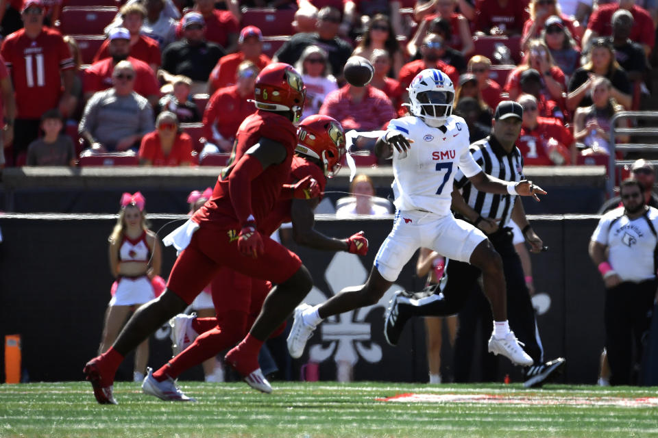 SMU quarterback Kevin Jennings (7) attempts a pass away from the Louisville defense during the first half of an NCAA college football game in Louisville, Ky., Saturday, Oct. 5, 2024. (AP Photo/Timothy D. Easley)