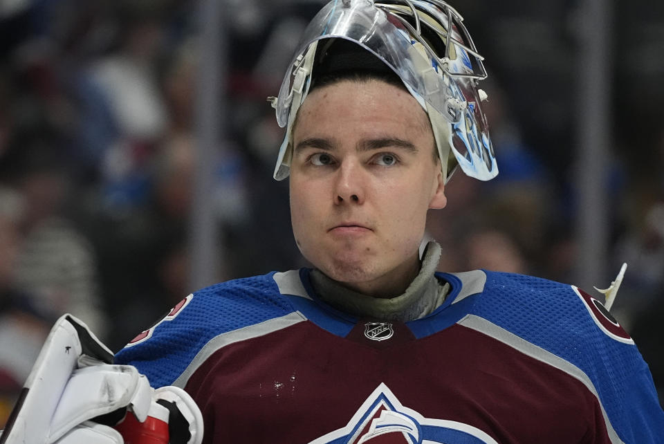 Colorado Avalanche goaltender Justus Annunen pulls up his mask for water during a time out in the second period of an NHL hockey game against the Montreal Canadiens Tuesday, March 26, 2024, in Denver. (AP Photo/David Zalubowski)
