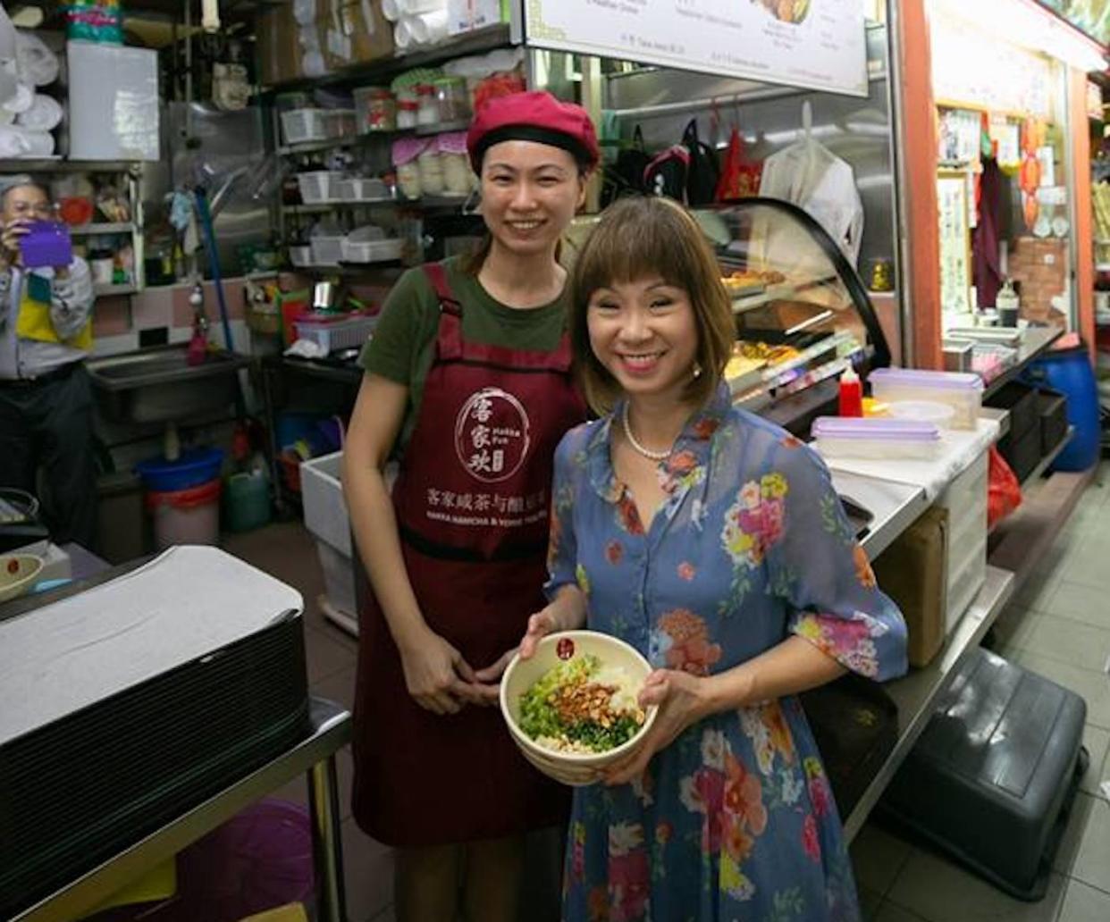 Senior Minister of State for the Environment and Water Resources Amy Khor with a young hawker at Chinatown Complex Food Centre. PHOTO: Amy Khor Facebook page