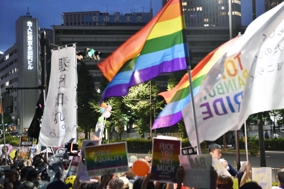 FILE - In this July 27, 2018, file photo, people protest in front of the ruling Liberal Democratic Party headquarters in Tokyo against the party lawmaker Mio Sugita. Sugita was condemned after saying in a magazine that the government shouldn't use tax money for the rights of LGBTQ individuals because they are “not productive.” Thirteen same-sex couples are filing Japan’s first lawsuits challenging the constitutionality of the country’s rejection of same-sex marriage on Valentine Day, Thursday, Feb. 14, 2019 in Tokyo. (Iori Sagisawa/Kyodo News via AP, File)