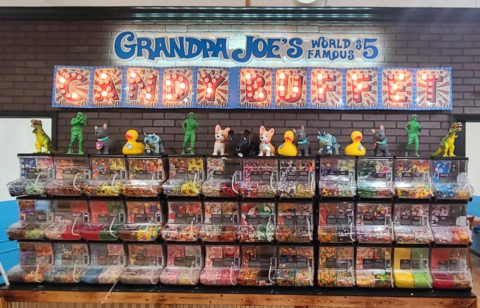 At the back of Grandpa Joe's Candy Shop sits the Candy Buffet where you can fill a box of candy with your favorite treats.