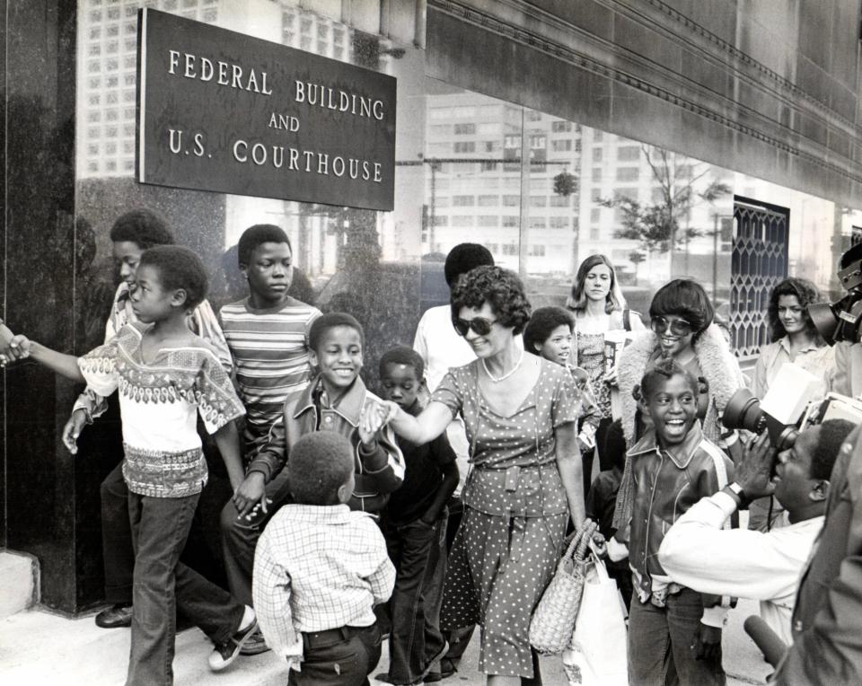 In 1977, the Student Advocate Center sued Ann Arbor Public Schools on behalf of about a dozen Black children. Here several people involved in the lawsuit interact with the media outside the Federal Building in Detroit.