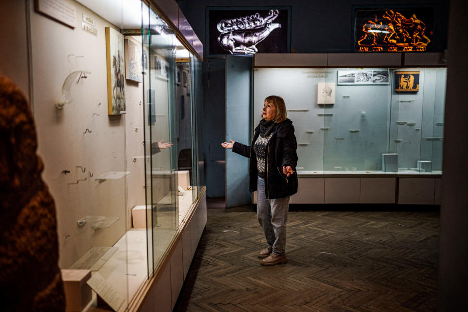 Olga Honcharova, temporary director of the Kherson Regional Museum, shows empty display cases in Kherson, Ukraine, on Dec. 22, 2022. (Dimitar Dilkoff / AFP via Getty Images file)