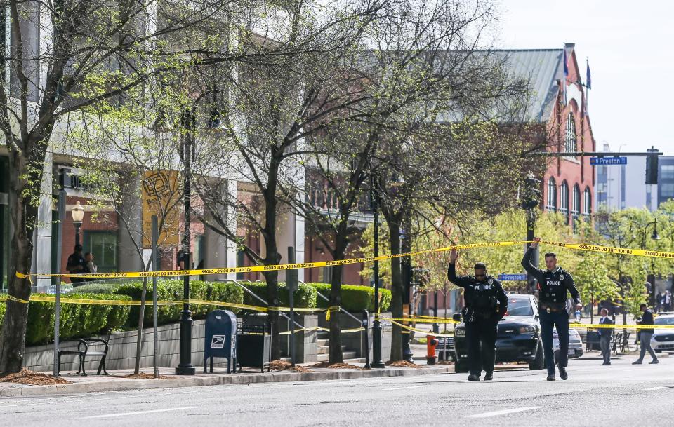 Police approach the scene in the aftermath of the Old National Bank shooting on April 10.