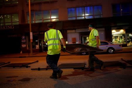 Workers erect security barricades as setup continues in advance of the Republican National Convention in Cleveland, Ohio July 15, 2016. REUTERS/Aaron P. Bernstein