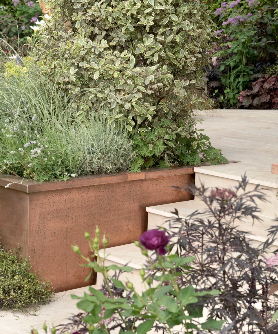 4. Pair pale, paved steps with Corten steel planters