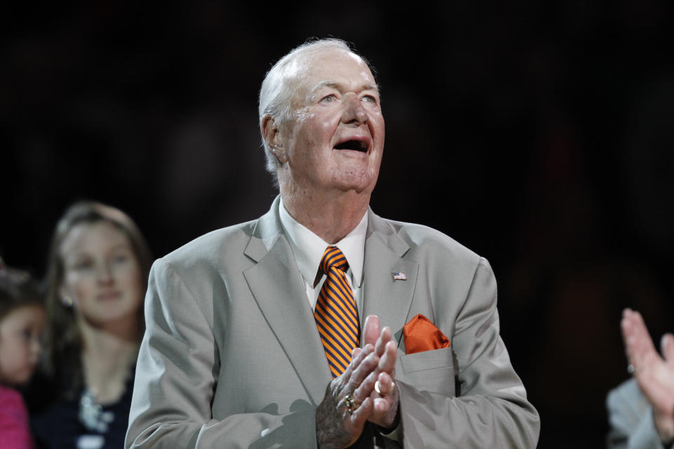 FILE - Former Indiana Pacers coach Bobby "Slick" Leonard watches a banner being hung in his honor during a presentation at half time of an NBA basketball game against the Philadelphia 76ers in Indianapolis, in this Wednesday, Oct. 29, 2014, file photo. Leonard, the former NBA player and Hall of Fame coach who won three ABA championships with the Indiana Pacers and spent more than a half century with the organization, has died. He was 88. His death was announced by the Pacers on Tuesday, April 13, 2021. (AP Photo/AJ Mast, File)