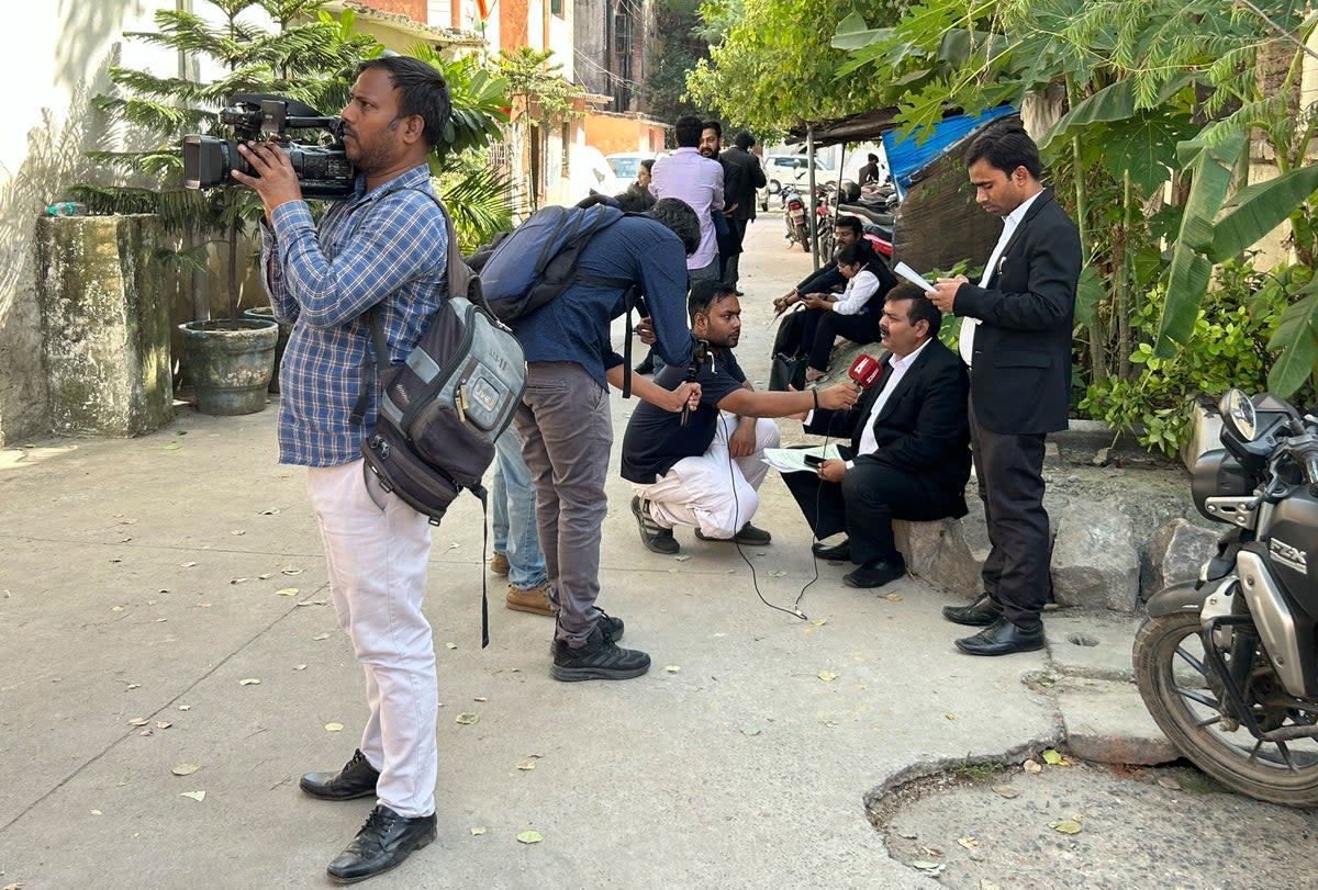 Journalists speak to lawyers outside the office of Delhi Police’s Special Cell in New Delhi, India, Tuesday, 3 October 2023 (AP)