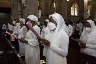 Churchgoers wear face masks to curb the spread of COVID-19 as they attend a Mass at All Saints Cathedral in Nairobi, Kenya, Friday, Dec. 24, 2021. (AP Photo/Sayyid Abdul Azim)