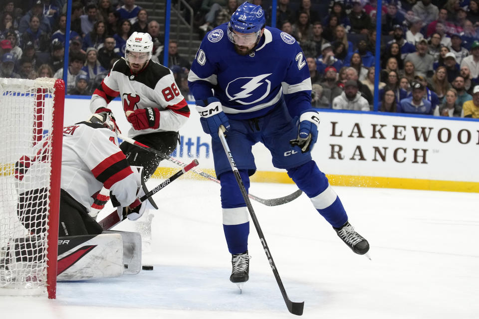 Tampa Bay Lightning left wing Nicholas Paul (20) gets a shot on New Jersey Devils goaltender Vitek Vanecek (41) during the second period of an NHL hockey game Thursday, Jan. 11, 2024, in Tampa, Fla. (AP Photo/Chris O'Meara)