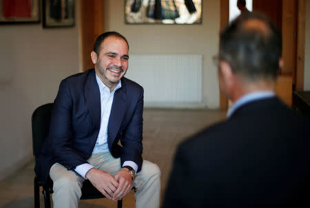 Jordan's Prince Ali Bin Al Hussein (L), president of the Jordanian Football Association, laughs with Reuters journalist Suleiman al-Khalidi after the end of the interview, in Amman, Jordan, October 23, 2016. REUTERS/Muhammad Hamed