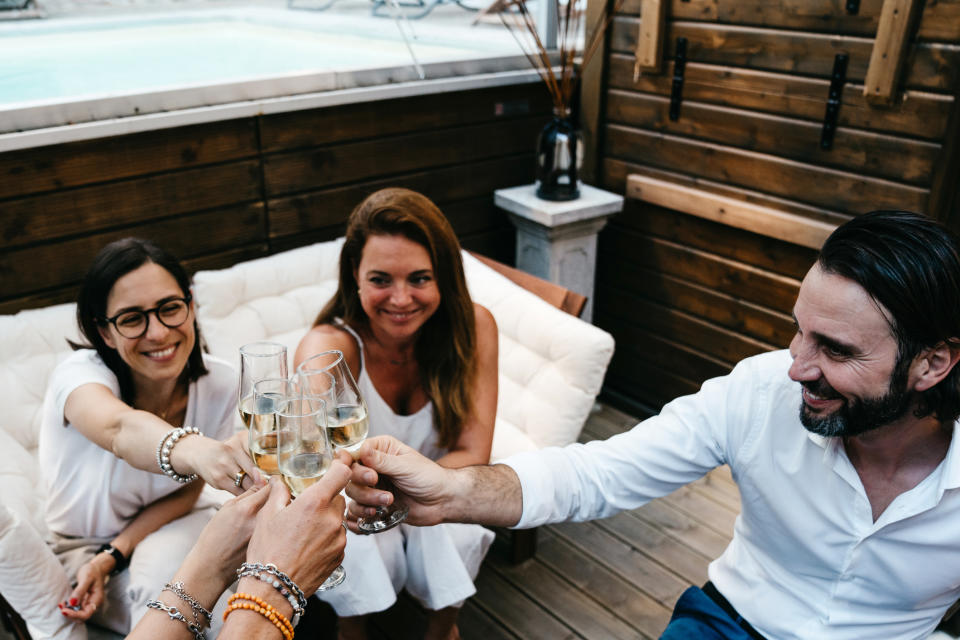 a group of friends toasting champagne glasses