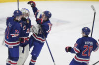 Team USA goaltender Trey Augustine (1) celebrates a win over Finland with teammates Ryan Chesley (71) and Lane Hutson (20) following third-period semifinal game action at the IIHF World Junior Hockey Championship in Gothenburg, Sweden, Thursday, Jan. 4, 2024. (Christinne Muschi/The Canadian Press via AP)