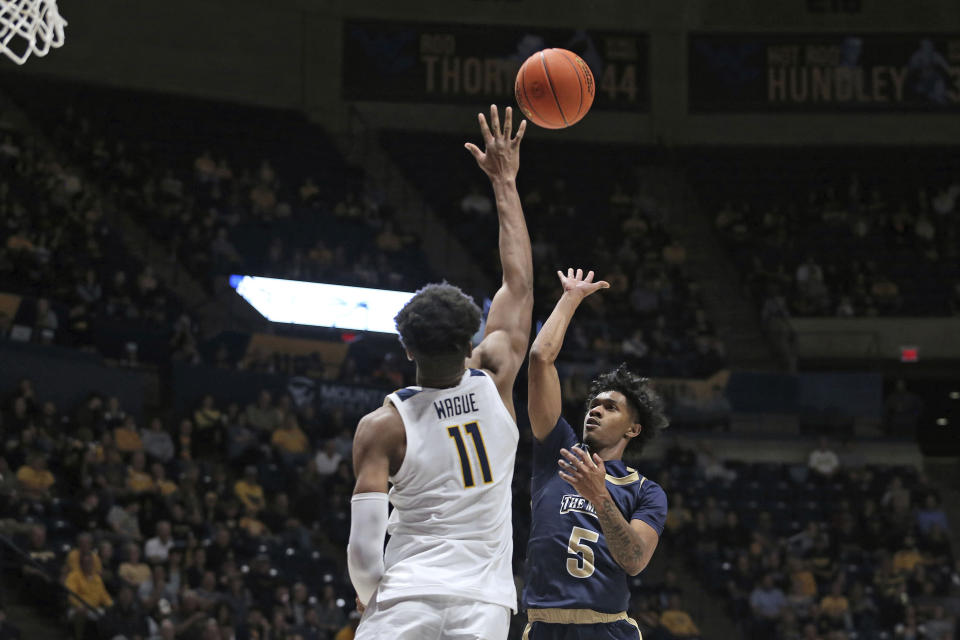 Mount St. Mary's guard Jalen Benjamin (5) shoots over West Virginia forward Mohamed Wague (11) during the first half of an NCAA college basketball game in Morgantown, W.Va., Monday, Nov. 7, 2022. (AP Photo/Kathleen Batten)