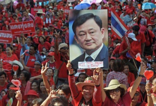 "Red Shirt" supporters hold a picture of fugitive former premier Thaksin Shinawatra during a demonstration in Bangkok on Saturday to mark the second anniversary of a deadly crackdown on street protests