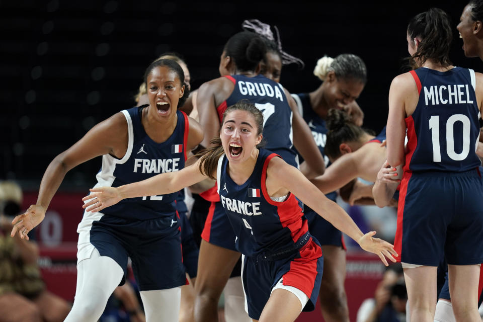 France's Marine Fauthoux (4) celebrates with teammates at the end of the women's basketball bronze medal game against Serbia at the 2020 Summer Olympics, Saturday, Aug. 7, 2021, in Saitama, Japan. (AP Photo/Charlie Neibergall)