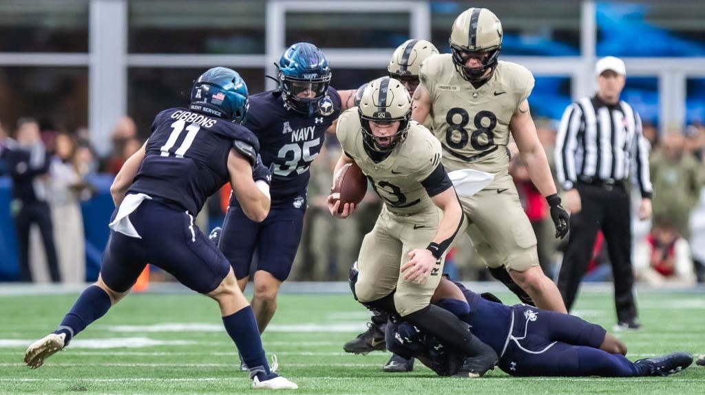  Bryson Daily #13 of the Army Black Knights runs for a short gain in the first quarter against the Navy Midshipmen at Gillette Stadium on December 9, 2023. 