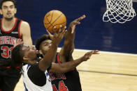 Minnesota Timberwolves center Naz Reid, left, shoots on Chicago Bulls forward Patrick Williams, right, in the second quarter during an NBA basketball game, Sunday, April 11, 2021, in Minneapolis. (AP Photo/Andy Clayton-King)