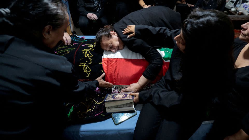 Fatma Kanso, the mother of Issam Abdallah, a Reuters videojournalist who was killed in southern Lebanon, mourns over her son's body during his funeral in his hometown of Al Khiyam, Lebanon, on October 14. - Zohra Bensemra/Reuters