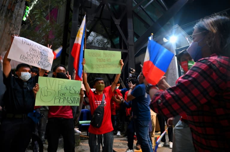 Supporters of Ferdinand Marcos Junior, who won the Philippines presidency in a landslide, celebrated the initial results outside the campaign's headquarters in Manila (AFP/CHAIDEER MAHYUDDIN)
