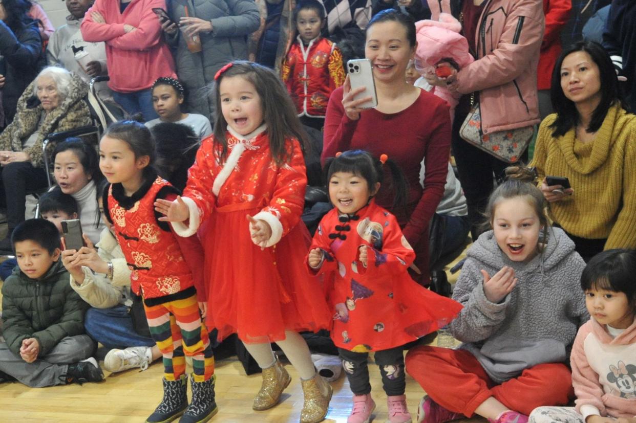 Families enjoy the performances during the annual Quincy Lunar New Year celebration hosted by Quincy Asian Resources Inc. at North Quincy High School on Sunday, Feb. 18, 2024.