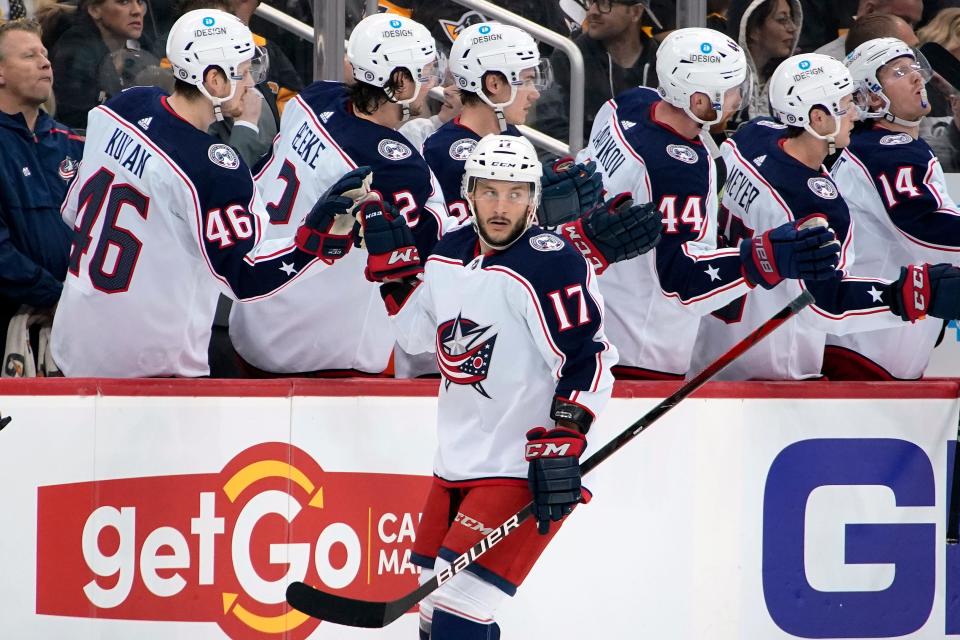 Columbus Blue Jackets' Justin Danforth (17) returns to the bench after scoring during the second period of an NHL hockey game against the Pittsburgh Penguins in Pittsburgh, Friday, April 29, 2022. (AP Photo/Gene J. Puskar)