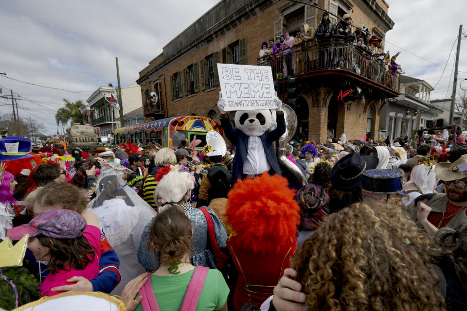 People walk in costumes during the Society of Saint Anne parade through Bywater and Marigny neighborhoods on Mardi Gras Day in New Orleans, Tuesday, Feb. 13, 2024. (AP Photo/Matthew Hinton)