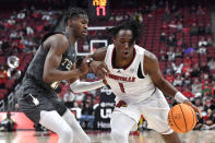 Louisville guard Mike James (1) drives on Georgia Tech guard Miles Kelly (13) during the second half of an NCAA college basketball game in Louisville, Ky., Wednesday, Feb. 1, 2023. Louisvile won 68-58. (AP Photo/Timothy D. Easley)