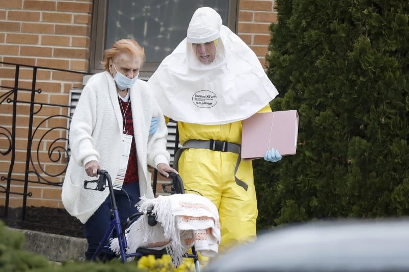 Medical officials aid a resident from St. Joseph's nursing home to board a bus, after a number of residents tested positive for coronavirus disease (COVID-19) in Woodbridge, New Jersey