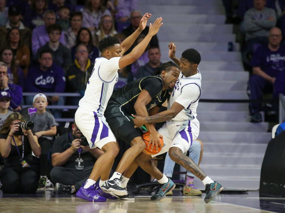 Kansas State guards Tylor Perry, left, and Cam Carter (5) double team Central Florida's Shmarri Allen (2) during their Big 12 opener Saturday at Bramlage Coliseum.