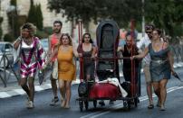 Participants of the Gay Pride parade leave the march after six people were stabbed, in central Jerusalem on July 30, 2015