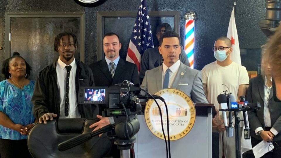 Jeffrey Thornton, second from left, looks on as President of the People’s Association of Justice Advocates Rev. Shane Harris speaks at a news conference on Tuesday, Nov. 30, 2021. (Photo credit: The People’s Association of Justice Advocates)