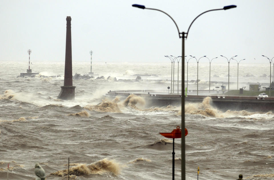 High waves crash against the sea wall during a heavy wind storm in Montevideo, Uruguay, Wednesday, Sept. 19, 2012. A powerful storm blew across the southern cone of South America, breaking windows in several buildings in Uruguay's capital, toppling about a hundred trees and cutting off three highways due to flooding. (AP Photo/Matilde Campodonico)