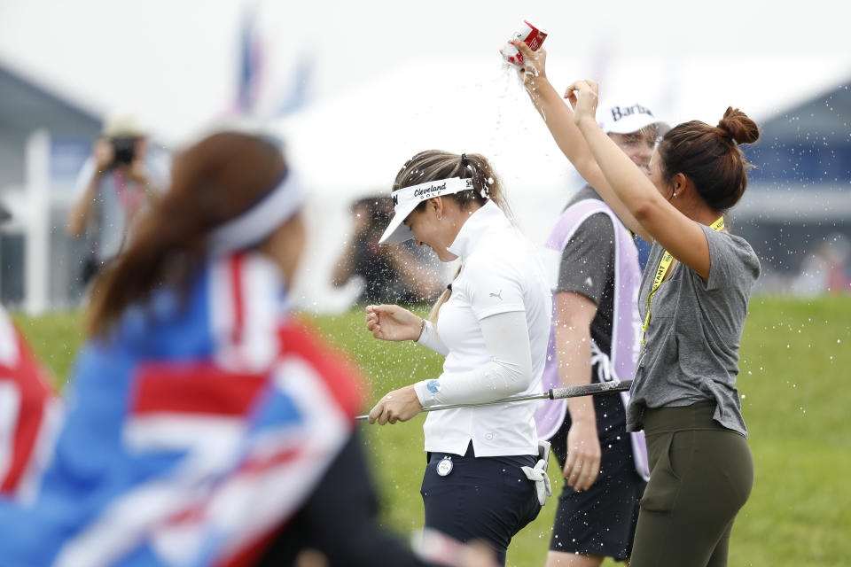 Hannah Green, center, of Australia, celebrates with fans after winning the KPMG Women's PGA Championship golf tournament, Sunday, June 23, 2019, in Chaska, Minn. (AP Photo/Charlie Neibergall)