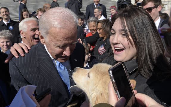 Copyright 2017 The Associated Press. All rights reserved. This material may not be published, broadcast, rewritten or redistributed without permission. Mandatory Credit: Photo by AP/REX/Shutterstock (8550223b) Former Vice President Joe Biden pets a dog as he greets the crowd on Capitol Hill in Washington, following an event marking seven years since former President Barack Obama signed the Affordable Care Act into law Congress Health Overhaul, Washington, USA - 22 Mar 2017