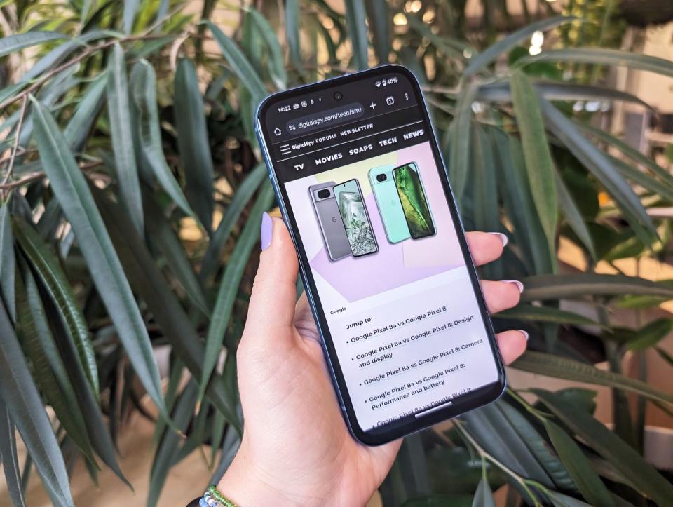 google pixel 8a held in hand with purple nails