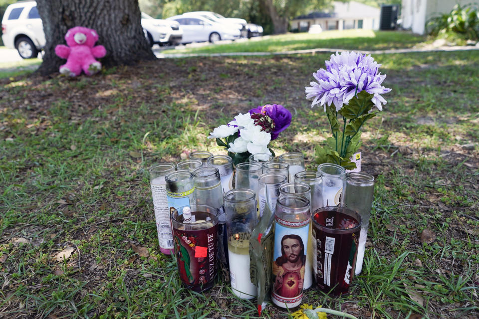 A small memorial is seen outside an apartment, Tuesday, June 6, 2023, in Ocala, Fla., where Ajike Owens, a 35-year-old mother of four was killed in a Friday night, June 2, shooting that Marion County Sheriff Billy Woods said was the culmination of a 2½-year feud between neighbors. Authorities came under intense pressure Tuesday to bring charges against a white woman who killed Owens, a Black neighbor on her front doorstep, as they navigated Florida’s divisive stand your ground law that provides considerable leeway to the suspect in making a claim of self defense. (AP Photo/John Raoux)