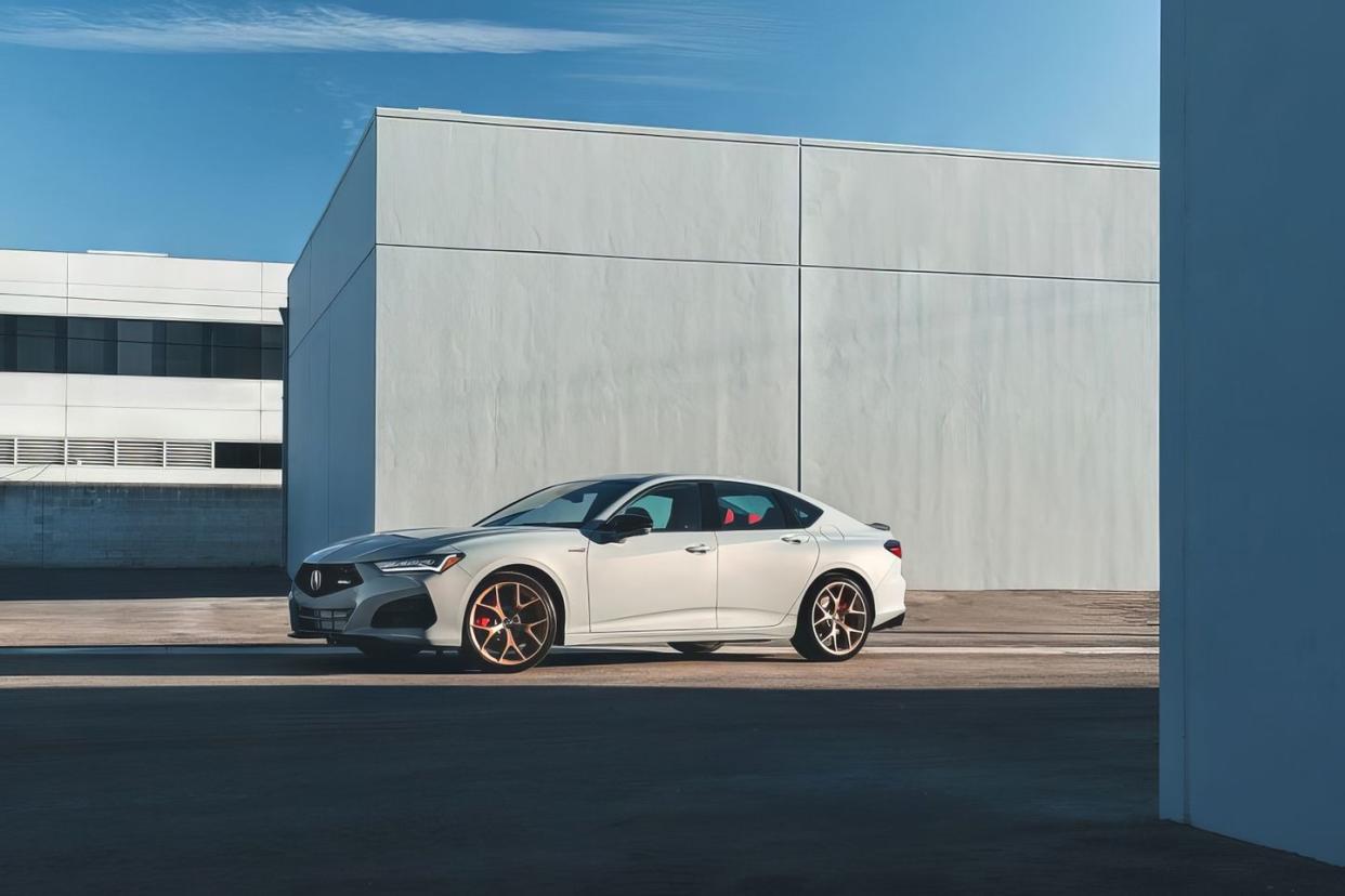 a white sports car parked in front of a building