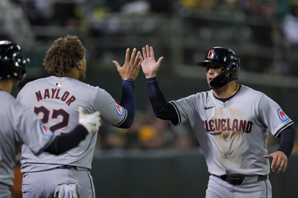 Cleveland Guardians’ Andres Giménez, right, celebrates with Josh Naylor after scoring against the Oakland Athletics on Brayan Rocchio’s two-run double during the fourth inning of a baseball game Thursday, March 28, 2024, in Oakland, Calif. (AP Photo/Godofredo A. Vásquez)