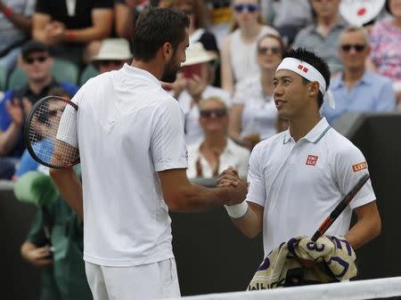 Britain Tennis - Wimbledon - All England Lawn Tennis & Croquet Club, Wimbledon, England - 4/7/16 Japan's Kei Nishikori with Croatia's Marin Cilic after retiring in their match due to injury REUTERS/Stefan Wermuth