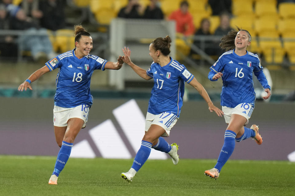 Italy's Arianna Caruso celebrates with her teammates Lisa Boattin, center, and Giulia Dragoni after scoring the opening goal during the Women's World Cup Group G soccer match between South Africa and Italy in Wellington, New Zealand, Wednesday, Aug. 2, 2023. (AP Photo/Alessandra Tarantino)
