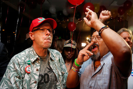 William Britt (L) and Al Moreno (R) celebrate after Californians voted to pass Prop 64, legalizing recreational use of marijuana in the state, in Los Angeles, California, U.S. November 8, 2016. REUTERS/Jonathan Alcorn