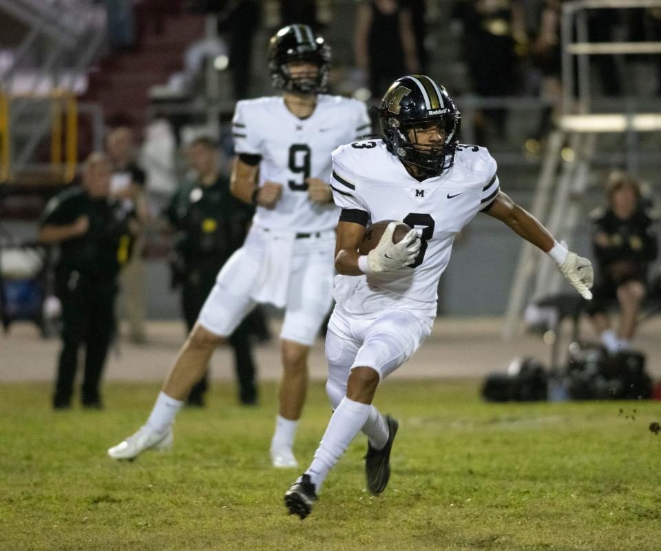 Milton wide receiver Trelin Carnegia (No. 3) runs for extra yards after a short field catch during Friday night's game against Navarre.